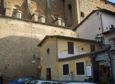 small building on a huge building background in florence, italy