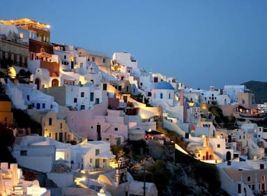popular white buildings with blue roofs in santorini, greece