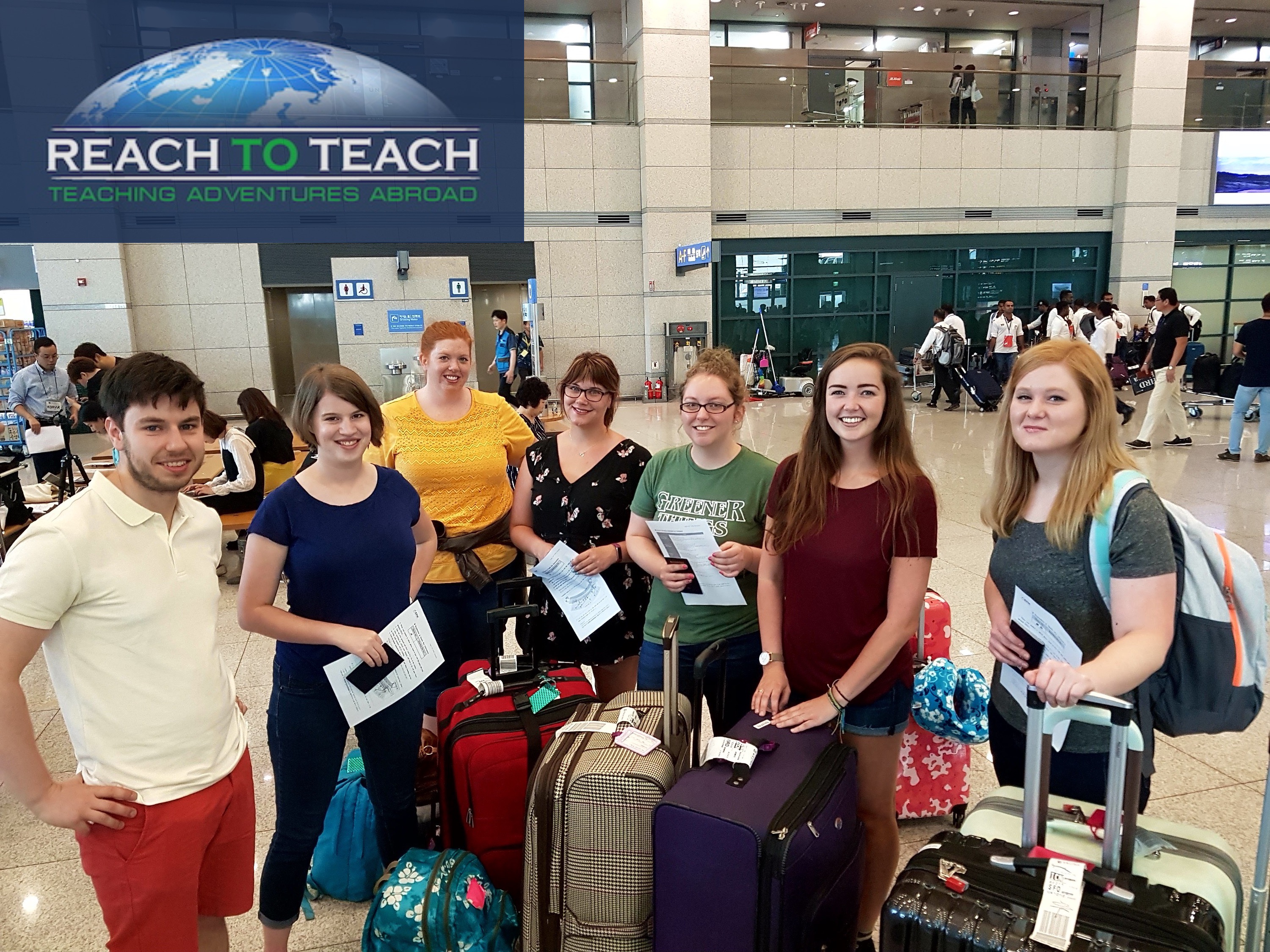 6 female and 1 male TEFL teacher in an airport arrival hall